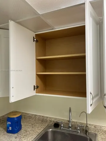 a room with a wooden floor and a sink