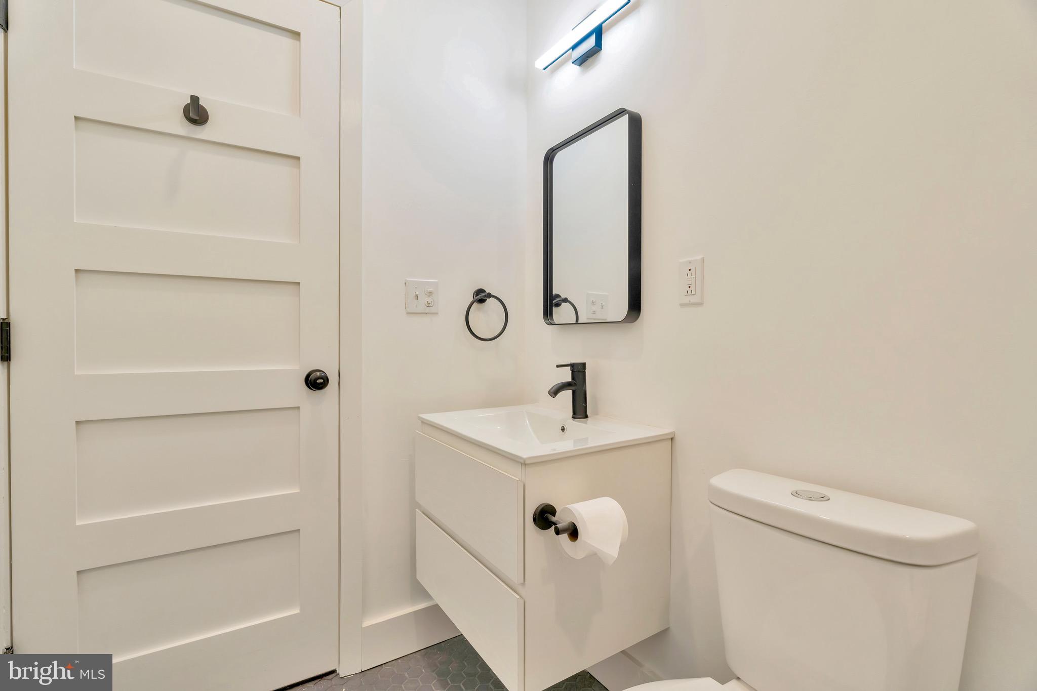 2138 Cross Street Philadelphia, PA 19146 - Photo 16 of 23 a bathroom with a sink and mirror with toilet