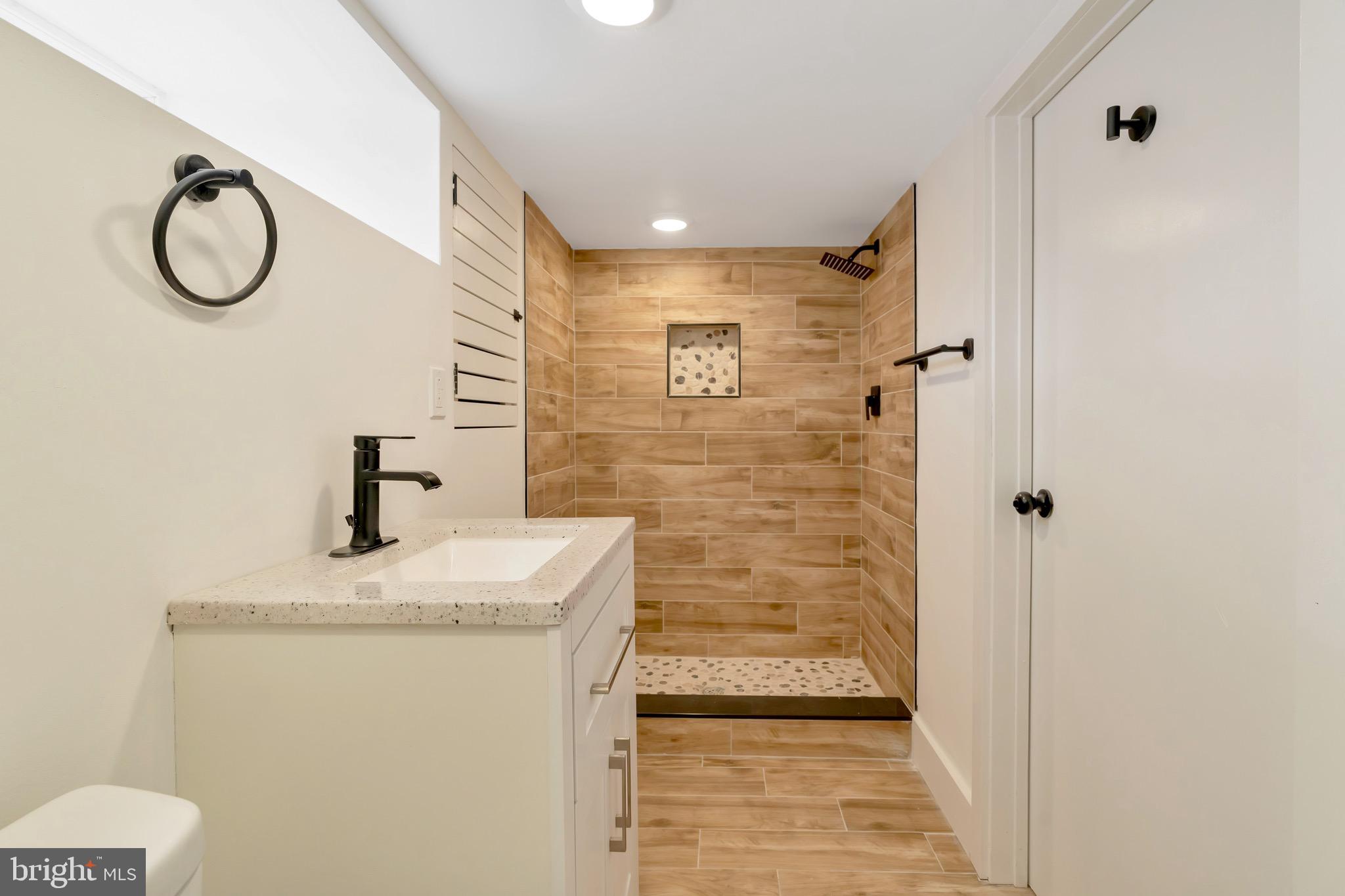 2138 Cross Street Philadelphia, PA 19146 - Photo 19 of 23 a bathroom with a sink a mirror and a shower