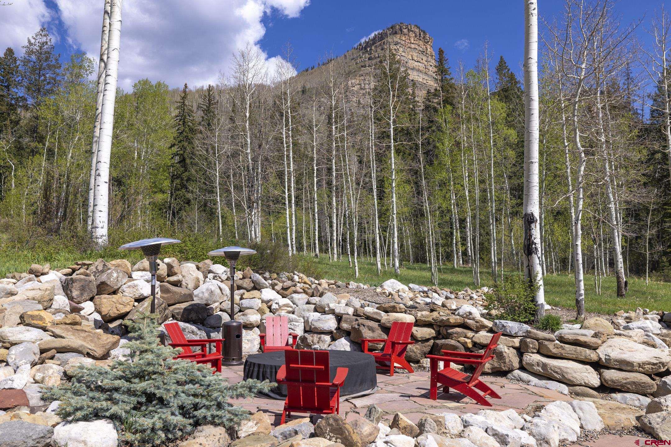 154 Falcon Ridge Road Durango, CO 81301 - Photo 4 of 42 a view of a chairs and table in a backyard