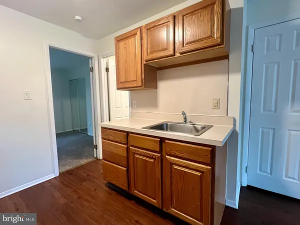 a kitchen with granite countertop wooden cabinets and a sink