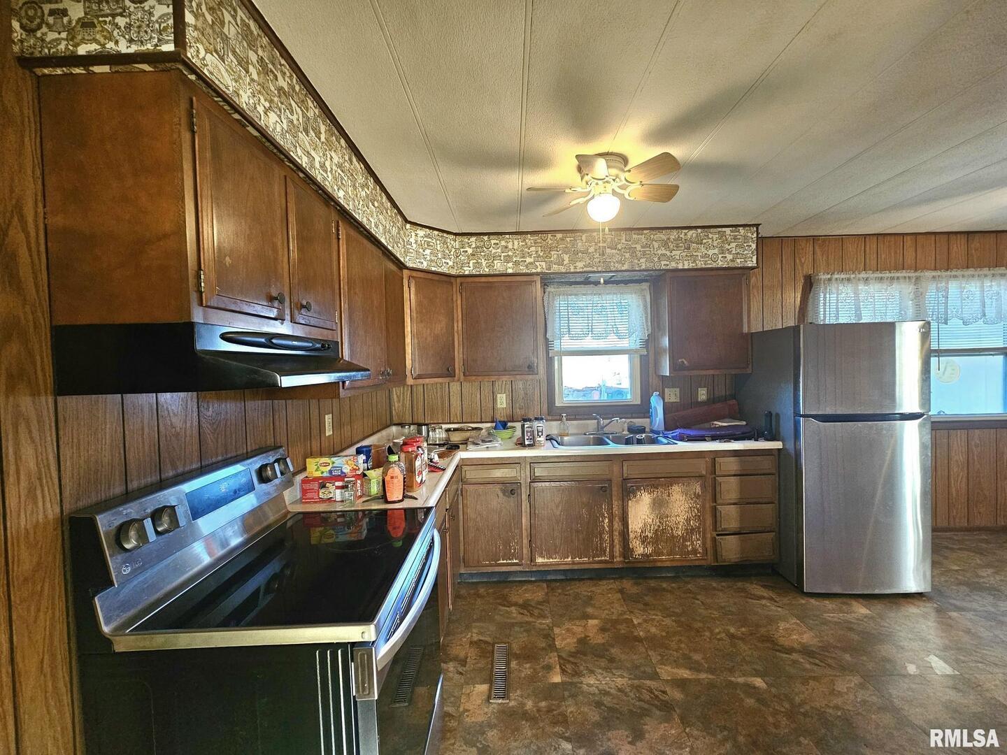 1093 Ocean Avenue Moscow, IA 52760 - Photo 5 of 10 a kitchen with kitchen island a stove a sink and a refrigerator