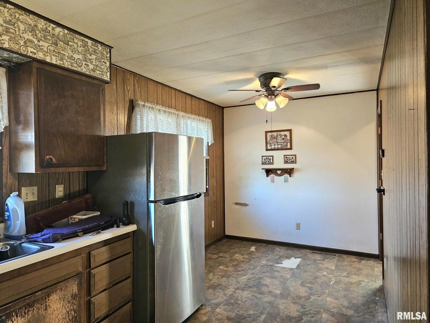 1093 Ocean Avenue Moscow, IA 52760 - Photo 6 of 10 a kitchen with stainless steel appliances a refrigerator and cabinets
