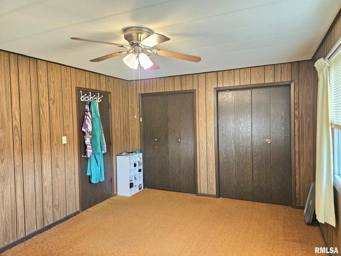 1093 Ocean Avenue Moscow, IA 52760 - Photo 8 of 10 a bedroom with a bed and a chandelier