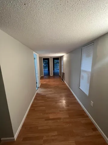 a view of a big room with wooden floor and fireplace