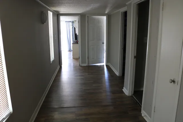 a view of a hallway with hardwood floor