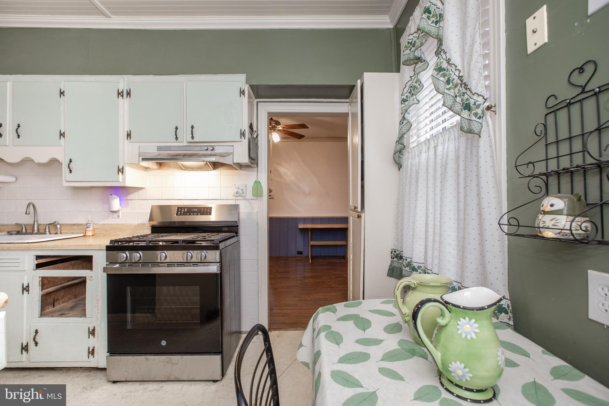 1530 Riverside Drive Trenton, NJ 08618 - Photo 12 of 36 a kitchen with stainless steel appliances a stove a chimney and a refrigerator