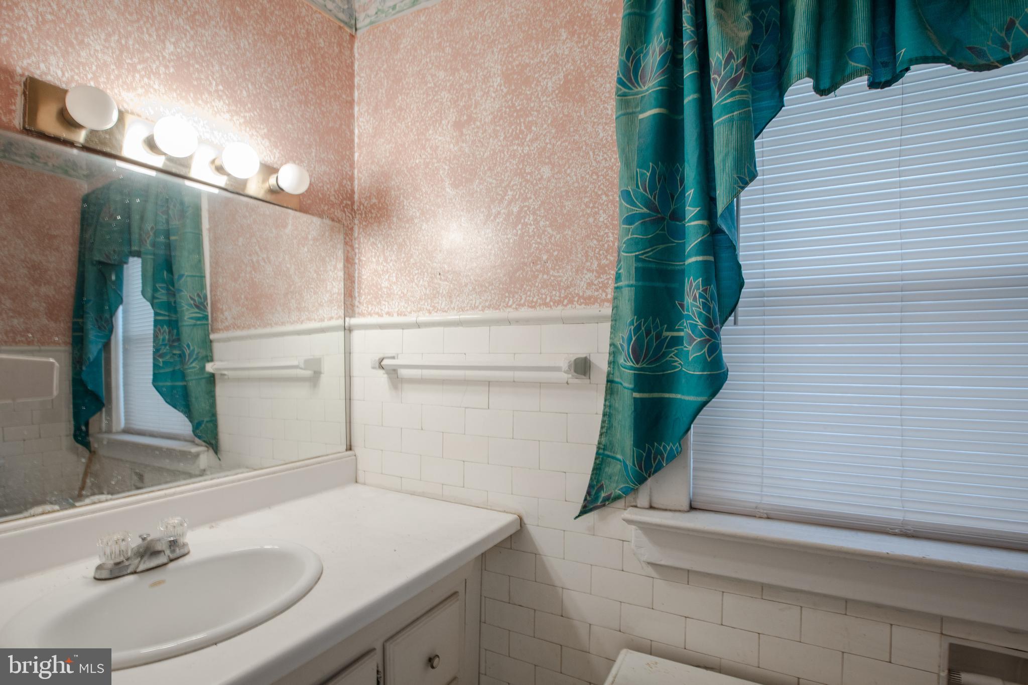 1530 Riverside Drive Trenton, NJ 08618 - Photo 25 of 36 a bathroom with a sink and a mirror