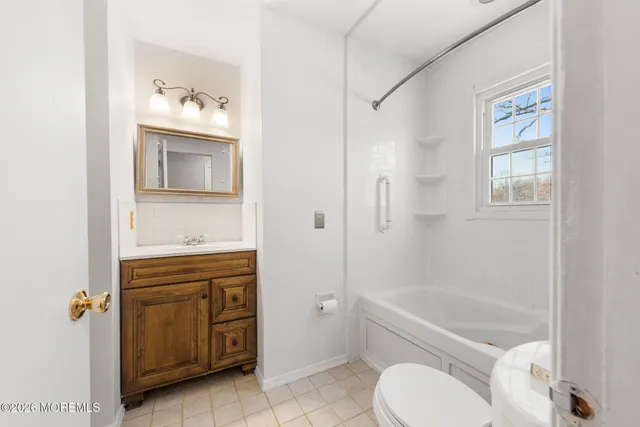 a white bath tub sitting next to a white sink