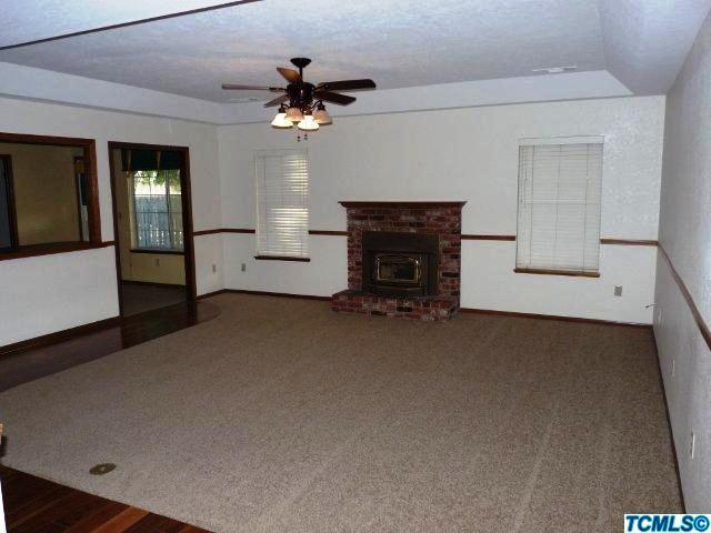 733 South Anderson Road Exeter, CA 93221 - Photo 8 of 17 a living room with furniture and a fireplace