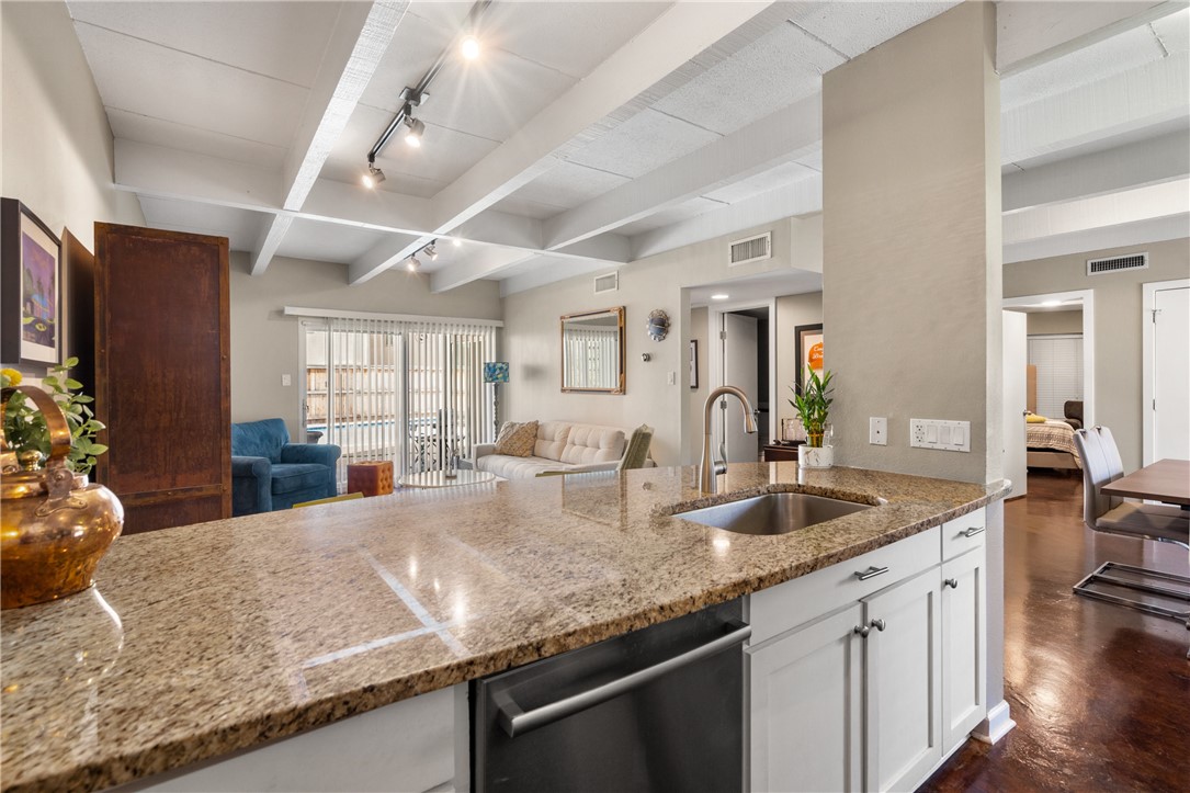 2308 Enfield Road, Unit 104 Austin, TX 78703 - Photo 1 of 1 a kitchen with granite countertop a sink and center island