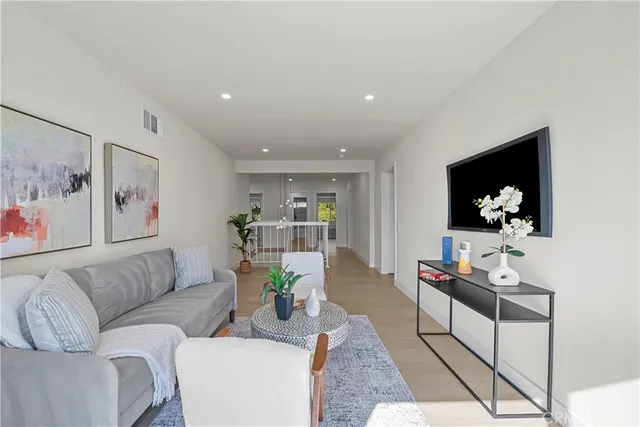 a spacious bedroom with a bed and ceiling fan