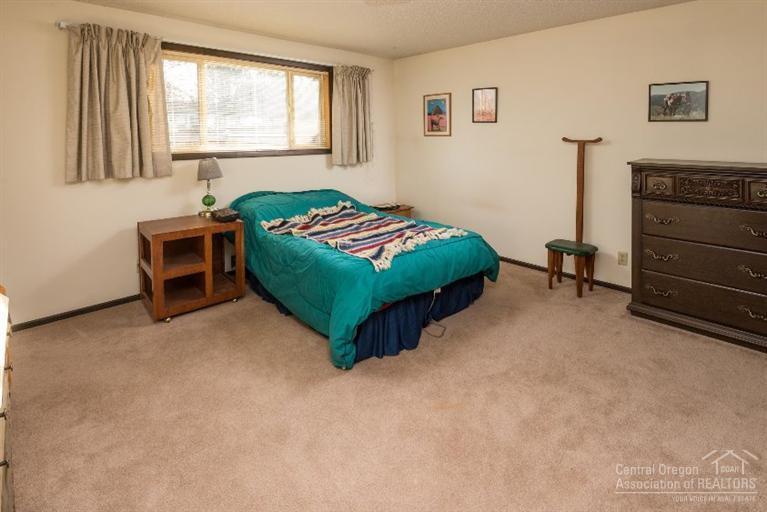61839 Dobbin Road Bend, OR 97702 - Photo 14 of 23 a bedroom with a bed and a dresser