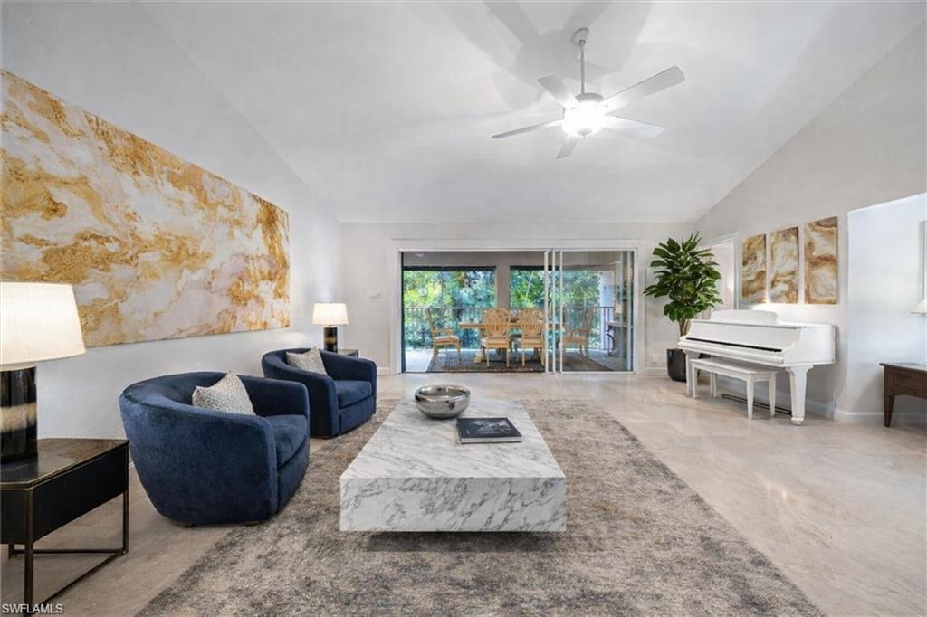 203 Via Perignon, Unit 24 Naples, FL 34119 - Photo 1 of 26 Living room with ceiling fan and vaulted ceiling virtually staged