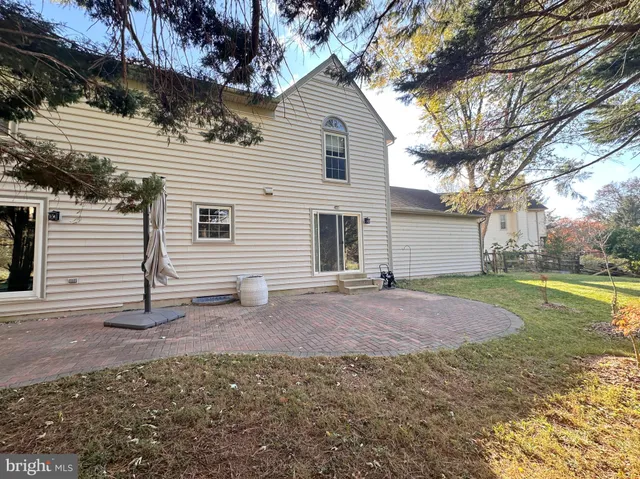 a view of a house with backyard and a tree
