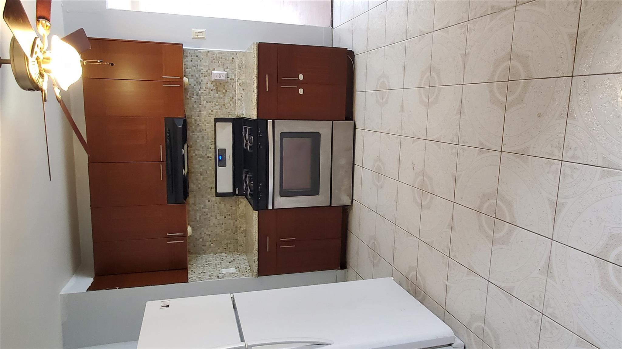 144-49 166th Street Queens, NY 11434 - Photo 4 of 15 Kitchen featuring ventilation hood, a ceiling fan, tasteful backsplash, fridge, and stainless steel gas range oven