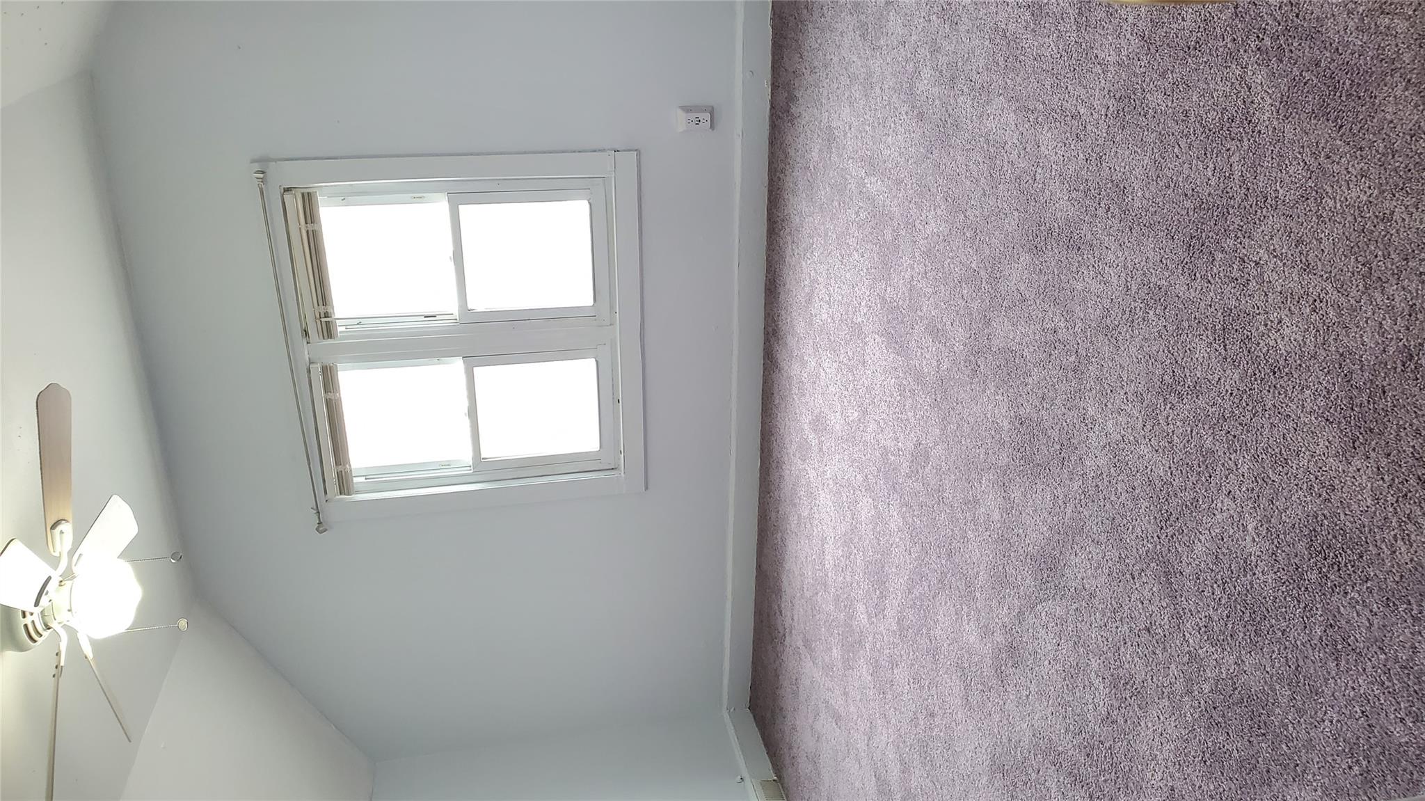 144-49 166th Street Queens, NY 11434 - Photo 7 of 15 Spare room with baseboards, carpet flooring, and lofted ceiling