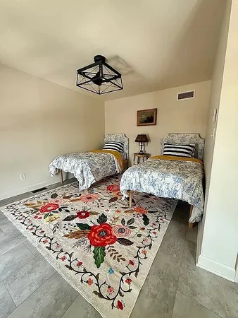 a living room with furniture a rug and a lamp