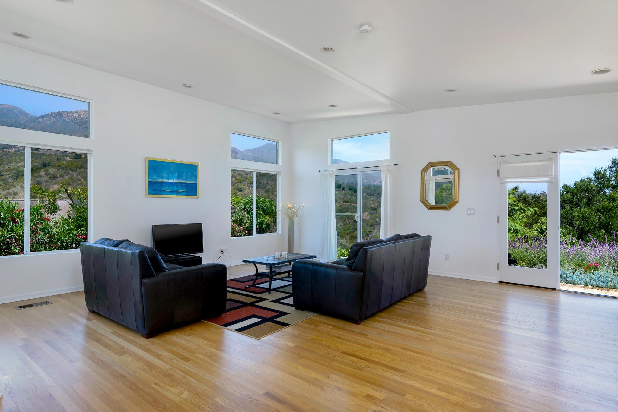317 Conejo Road Santa Barbara, CA 93103 - Photo 2 of 15 a living room with furniture and a flat screen tv