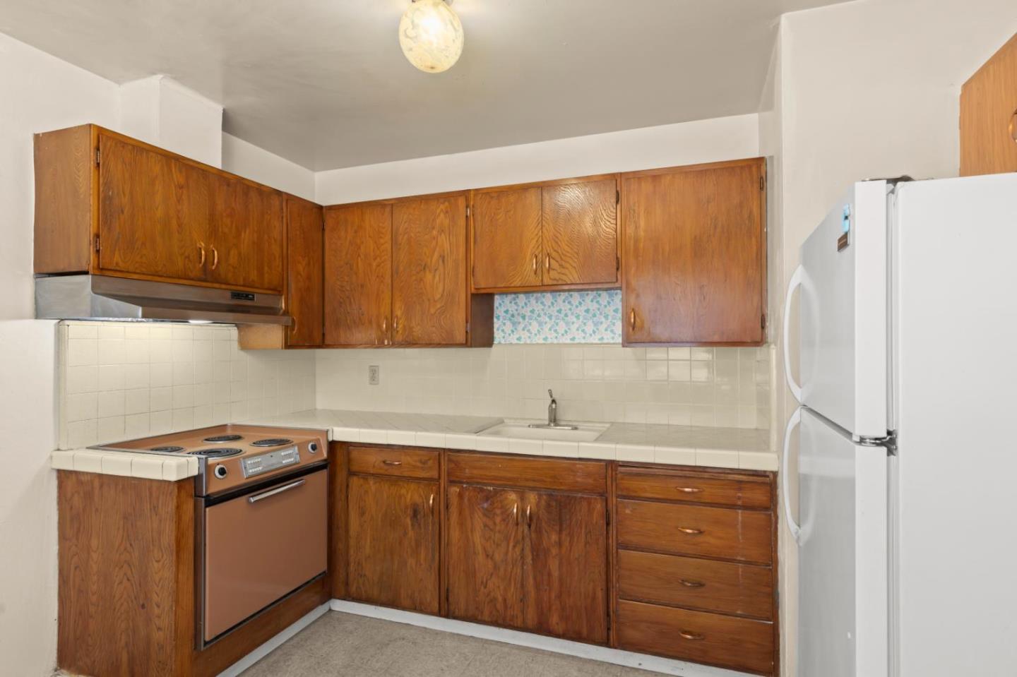 311 7th Street Davis, CA 95616 - Photo 6 of 18 a kitchen with a sink a stove cabinets and a window