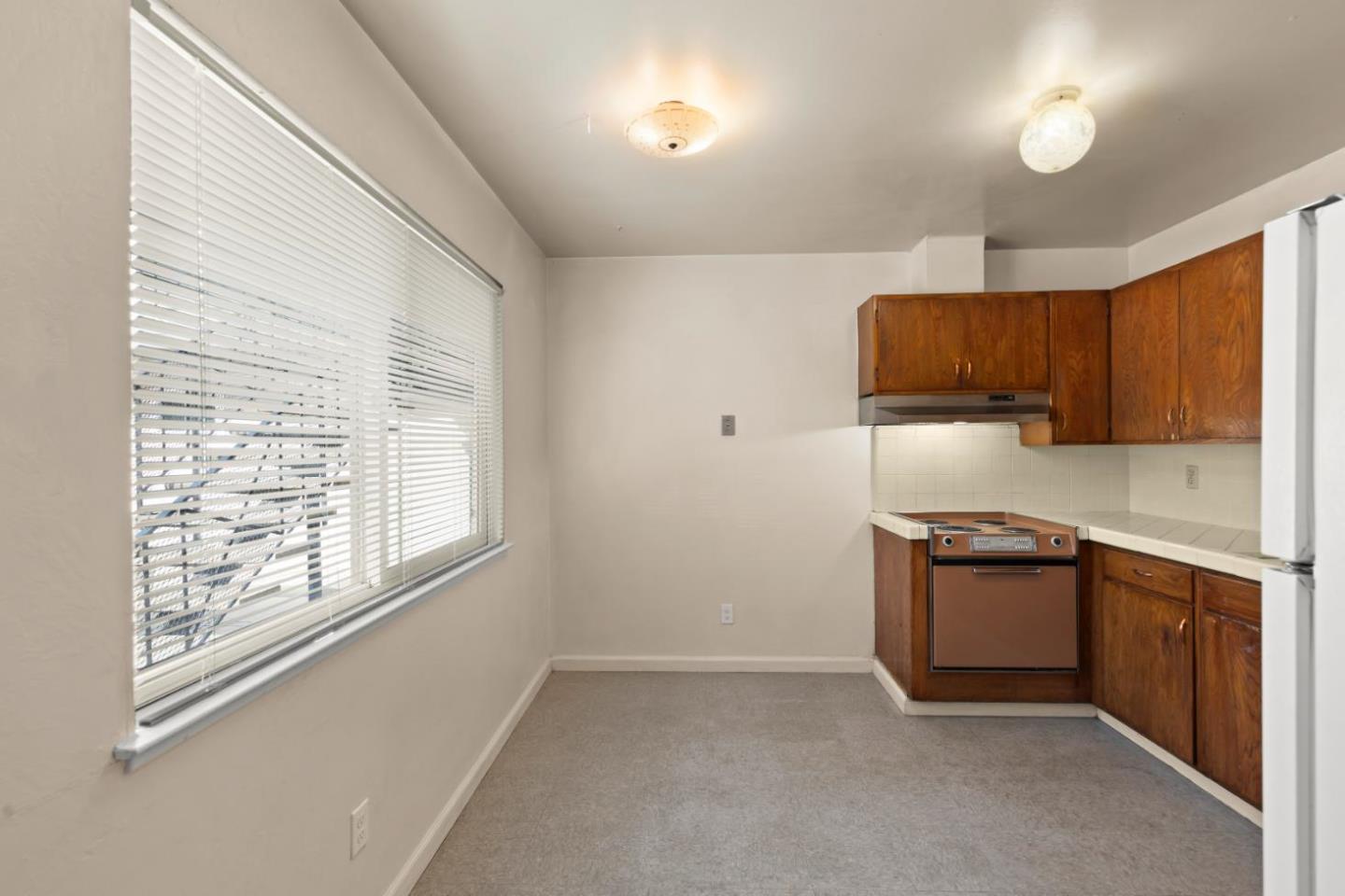 311 7th Street Davis, CA 95616 - Photo 7 of 18 a kitchen with stainless steel appliances granite countertop a stove a sink and a refrigerator