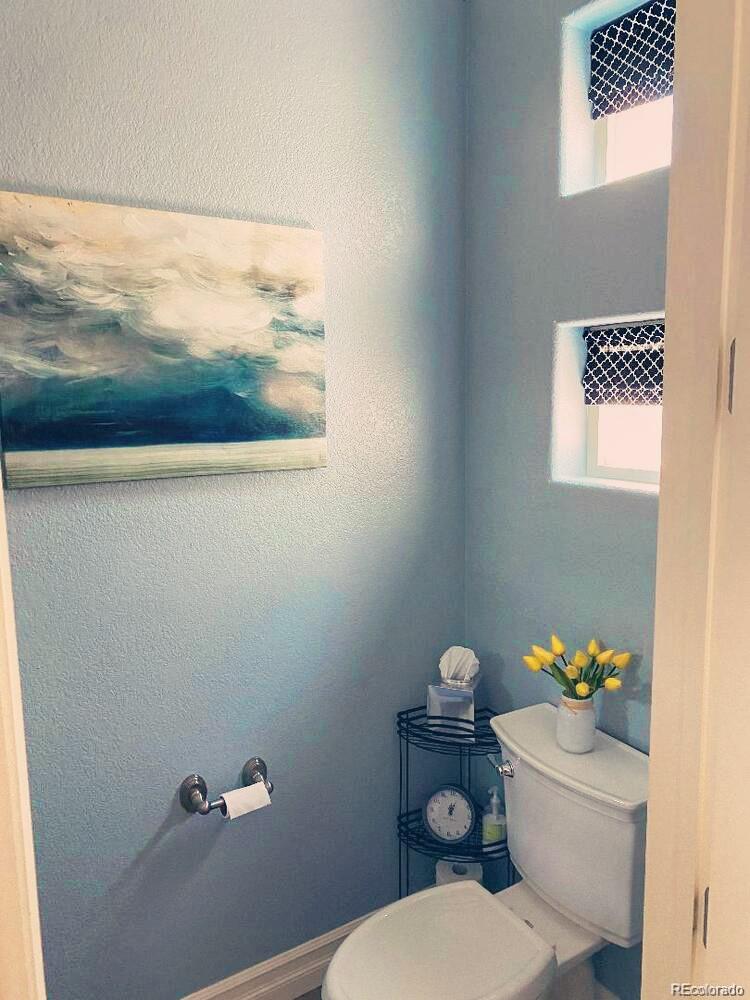 2323 Decatur Street Denver, CO 80211 - Photo 13 of 40 a bathroom with a toilet a sink and mirror