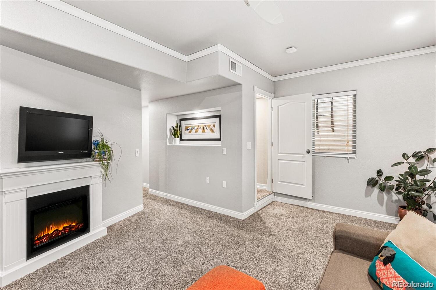 2323 Decatur Street Denver, CO 80211 - Photo 20 of 40 a living room with furniture and a flat screen tv