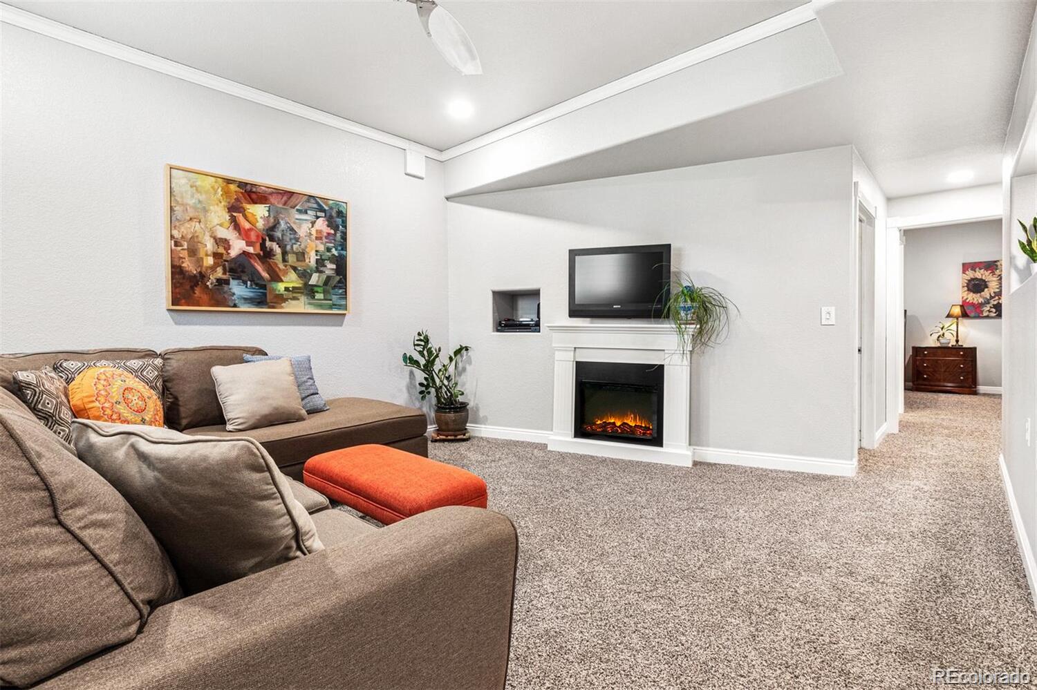 2323 Decatur Street Denver, CO 80211 - Photo 21 of 40 a living room with furniture a fireplace and a flat screen tv
