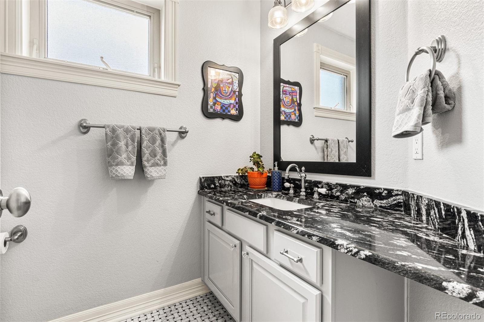 2323 Decatur Street Denver, CO 80211 - Photo 27 of 40 a bathroom with a sink and a mirror