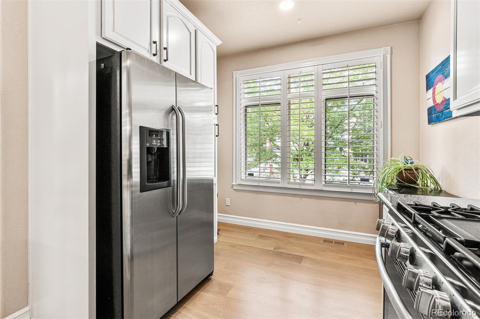2323 Decatur Street Denver, CO 80211 - Photo 8 of 40 a kitchen with stainless steel appliances granite countertop a refrigerator and a stove top oven