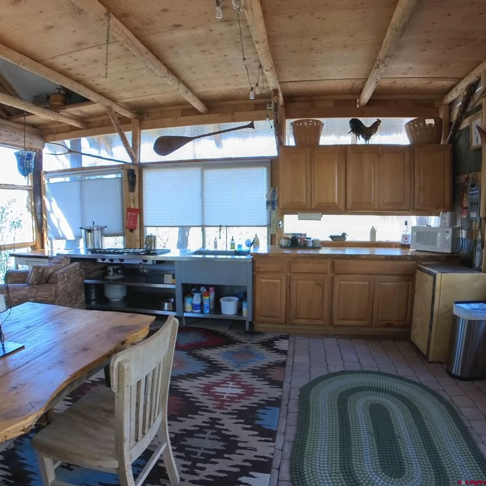 24279 Ute Trail Road Cedaredge, CO 81413 - Photo 4 of 15 a kitchen with a sink a stove and wooden cabinets
