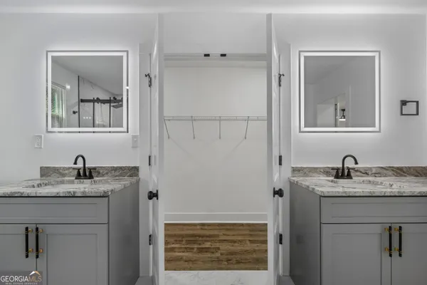 a bathroom with a granite countertop sink and a mirror