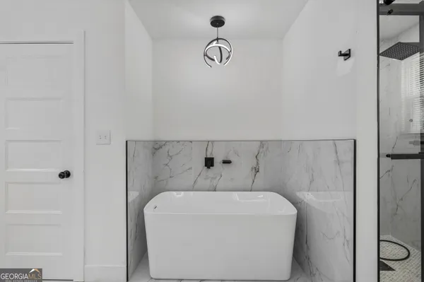 a bathroom with a bathtub and shower