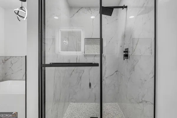 a bathroom with a shower and a mirror
