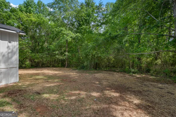 a view of a yard with a tree