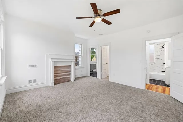 a bathroom with a granite countertop sink toilet a shower and a mirror