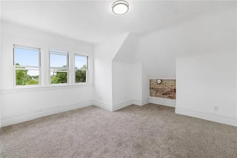 an empty room with windows and entrance