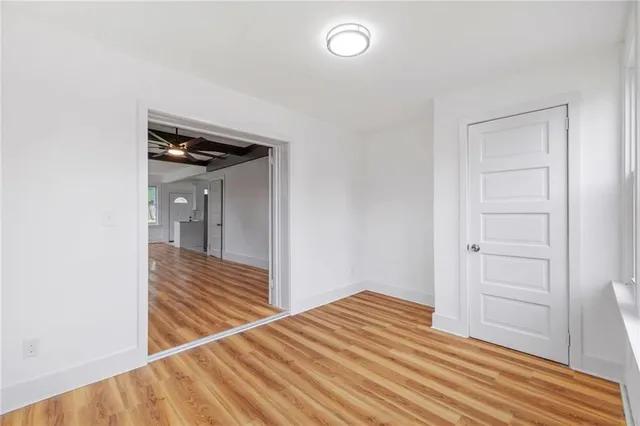 a view of a room with wooden floor and closet