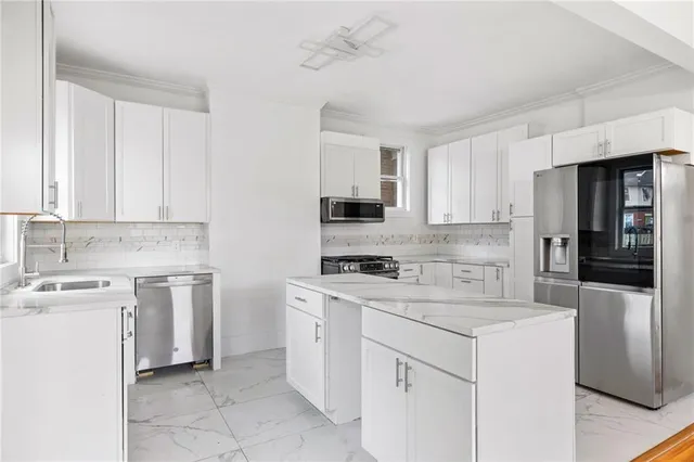 a kitchen with cabinets stainless steel appliances and a counter space