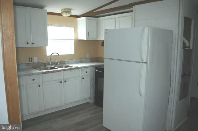 a white refrigerator freezer sitting inside of a kitchen