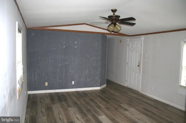a view of room with hardwood floor and ceiling fan