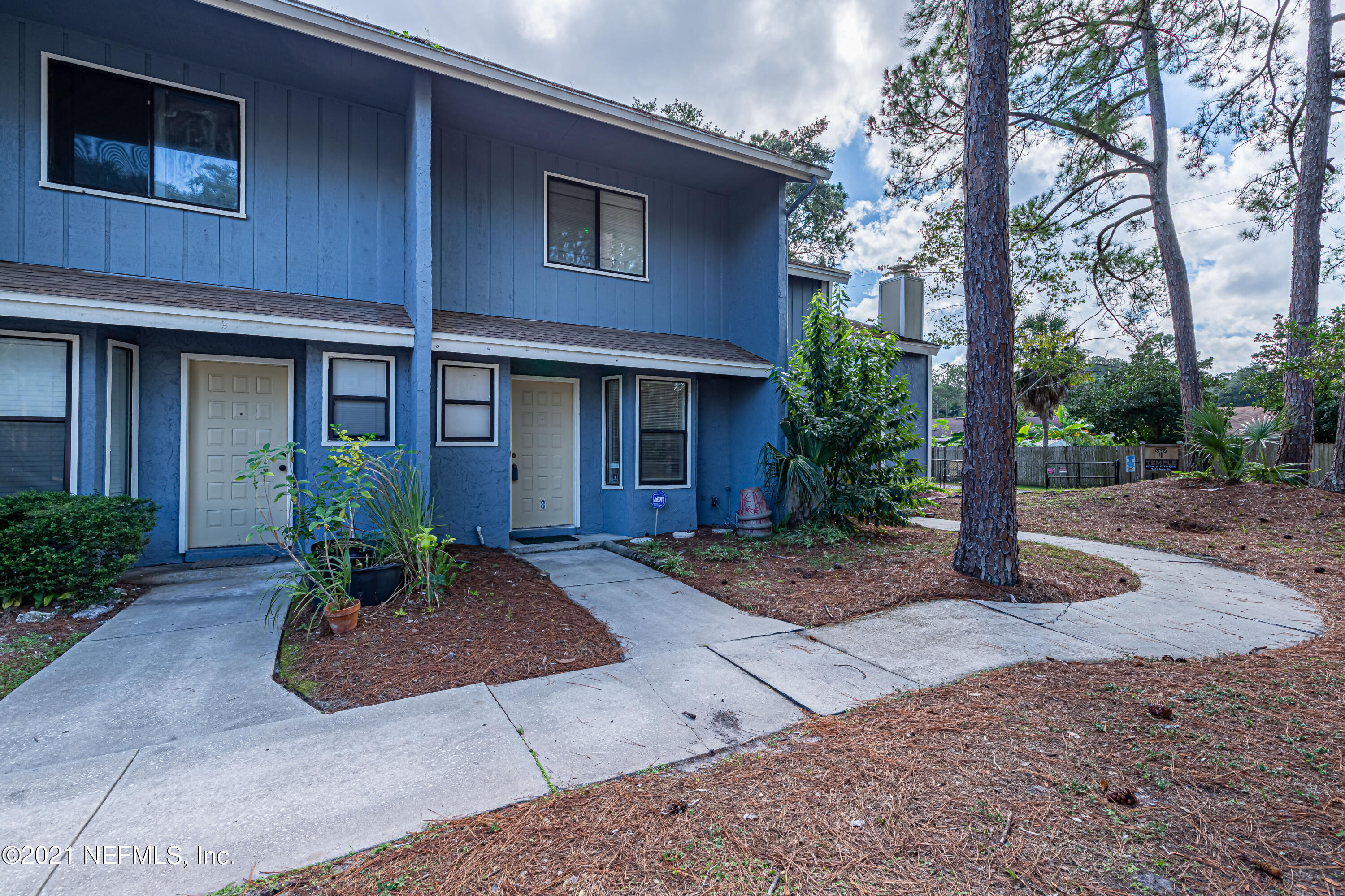 3517 Peeler Road, Unit 8 Jacksonville, FL 32277 - Photo 1 of 29 a front view of a house with garden
