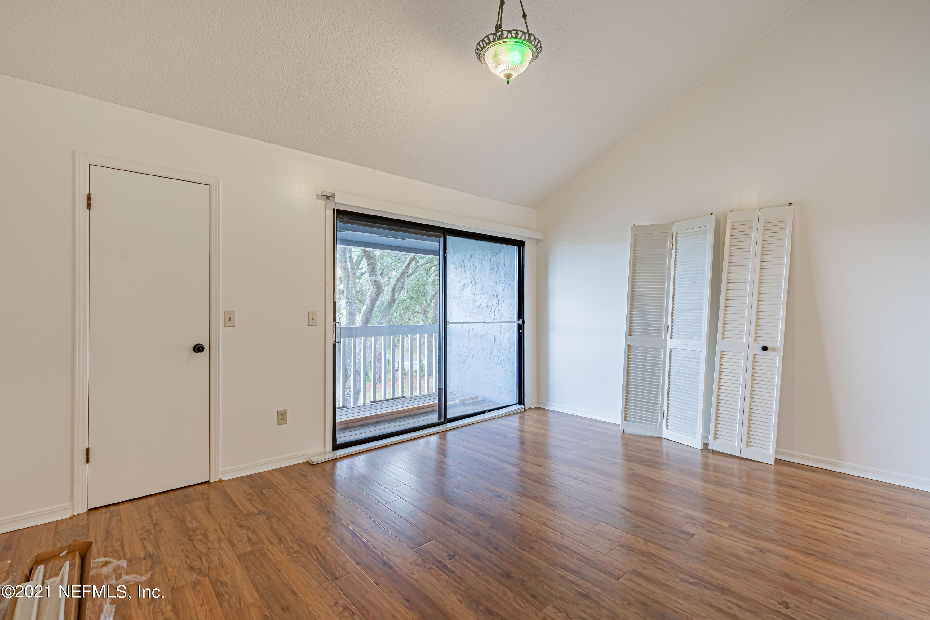 3517 Peeler Road, Unit 8 Jacksonville, FL 32277 - Photo 14 of 29 a view of an empty room with window and wooden floor