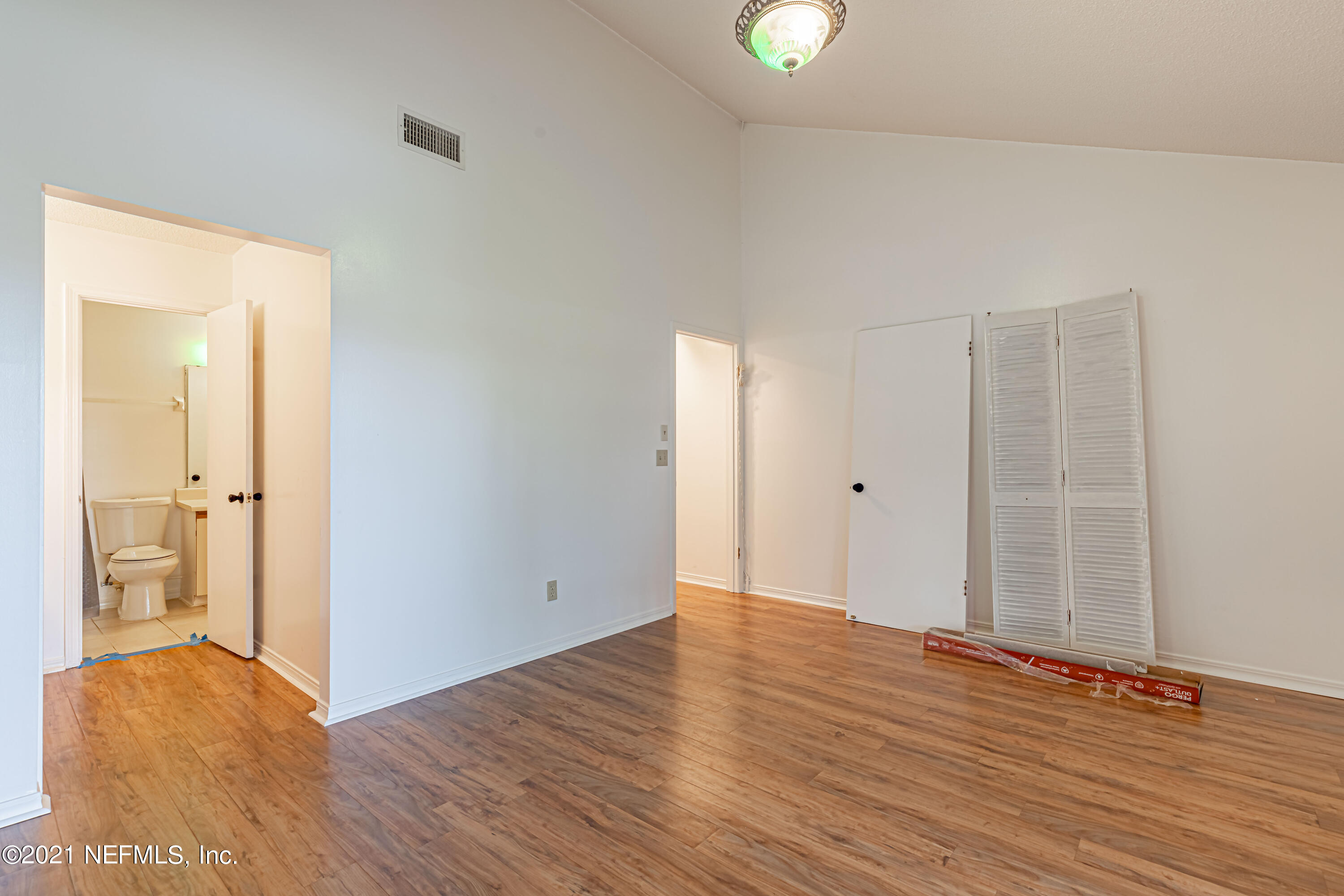 3517 Peeler Road, Unit 8 Jacksonville, FL 32277 - Photo 16 of 29 an empty room with wooden floor and windows