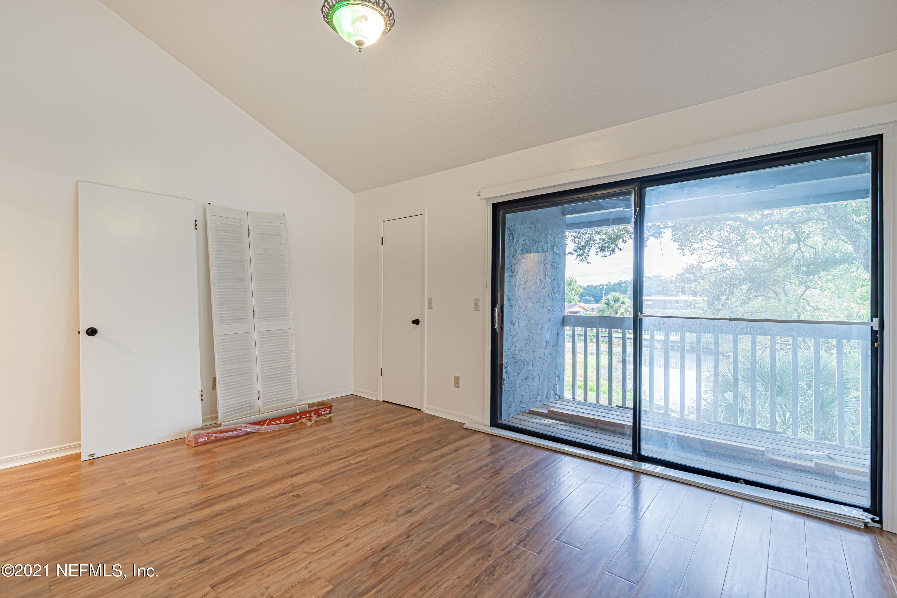 3517 Peeler Road, Unit 8 Jacksonville, FL 32277 - Photo 17 of 29 a view of empty room with wooden floor and fan