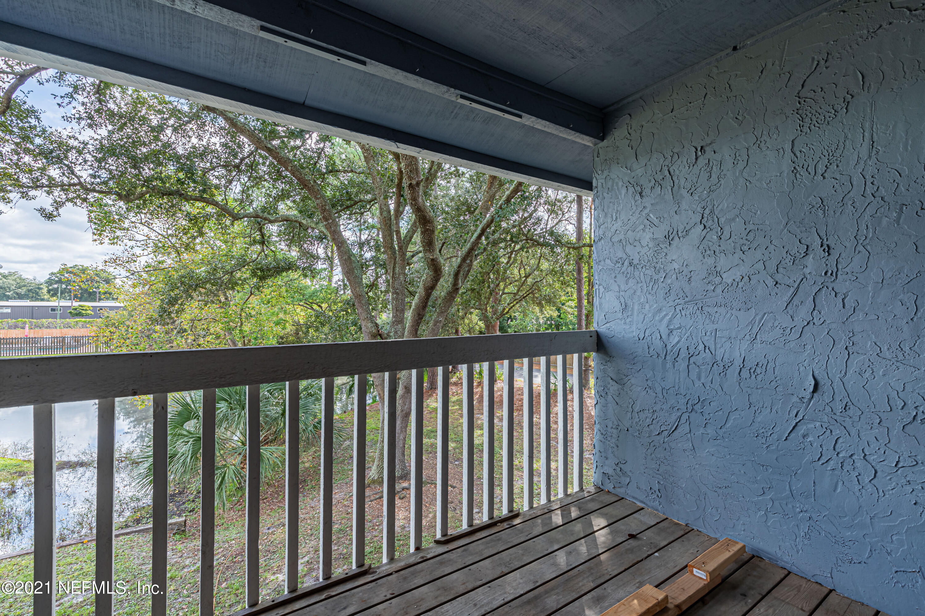 3517 Peeler Road, Unit 8 Jacksonville, FL 32277 - Photo 21 of 29 a view of a balcony with wooden floor