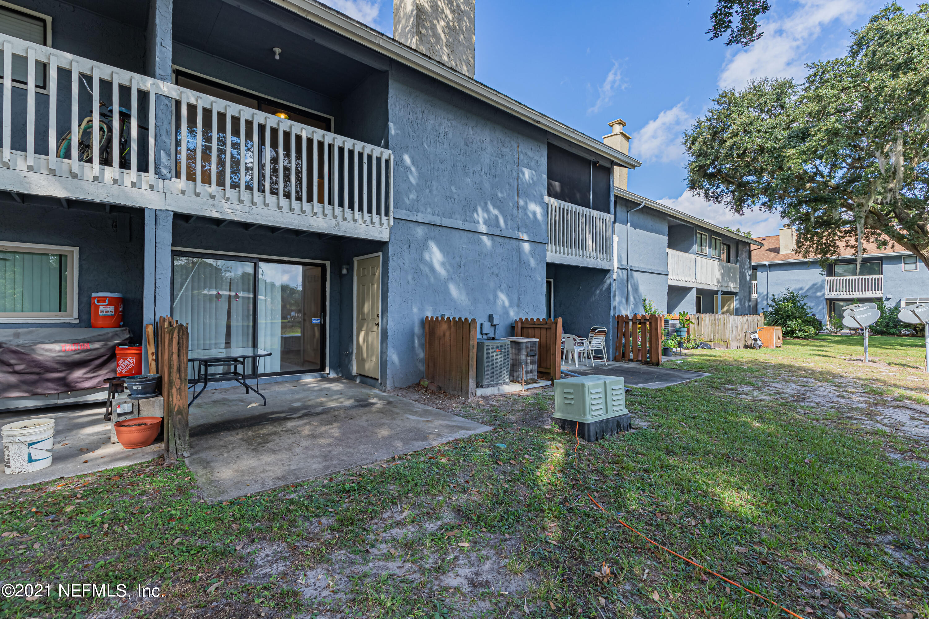 3517 Peeler Road, Unit 8 Jacksonville, FL 32277 - Photo 26 of 29 a view of a house with backyard porch and sitting area