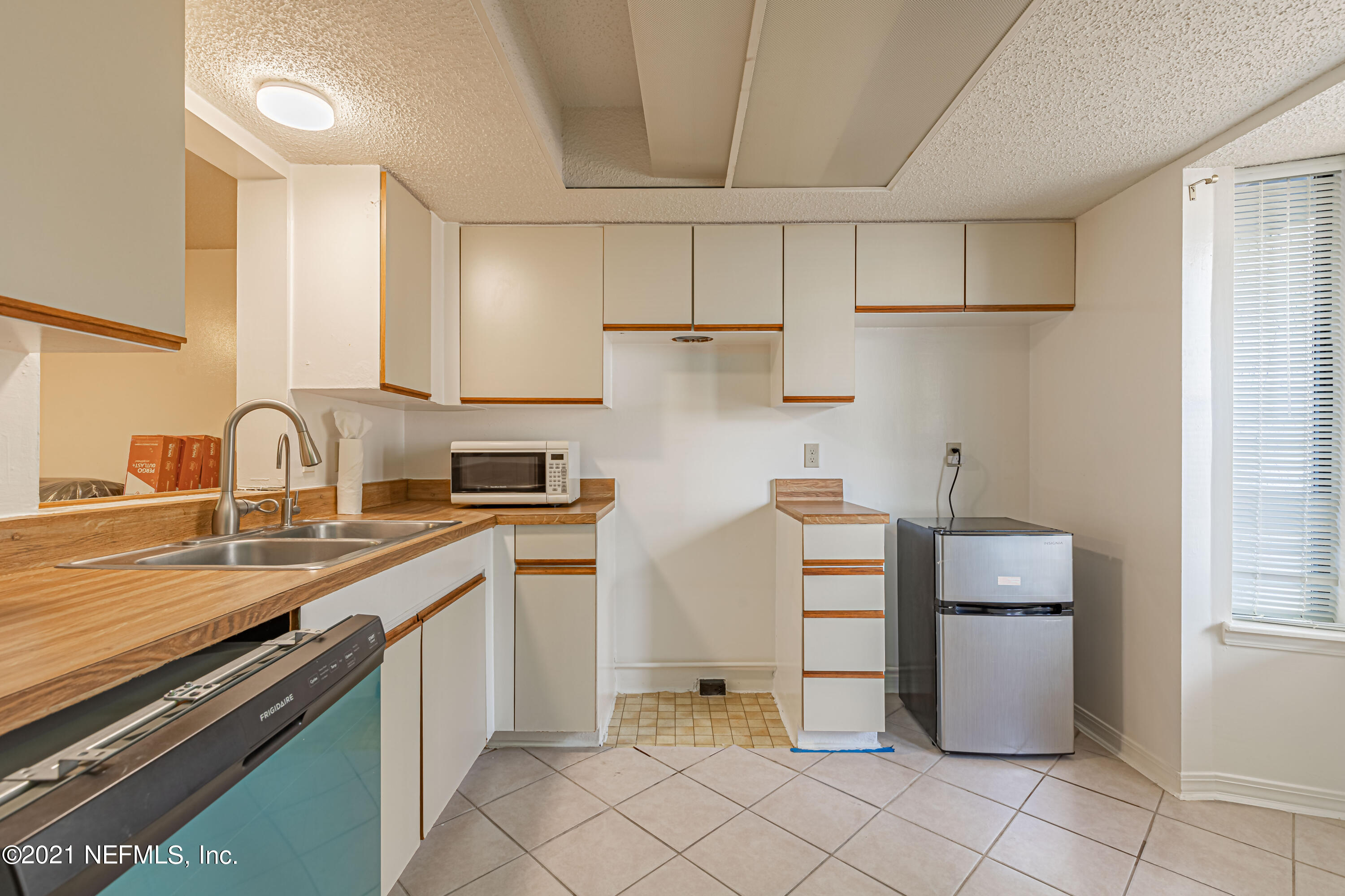 3517 Peeler Road, Unit 8 Jacksonville, FL 32277 - Photo 6 of 29 a kitchen with a sink cabinets and appliances