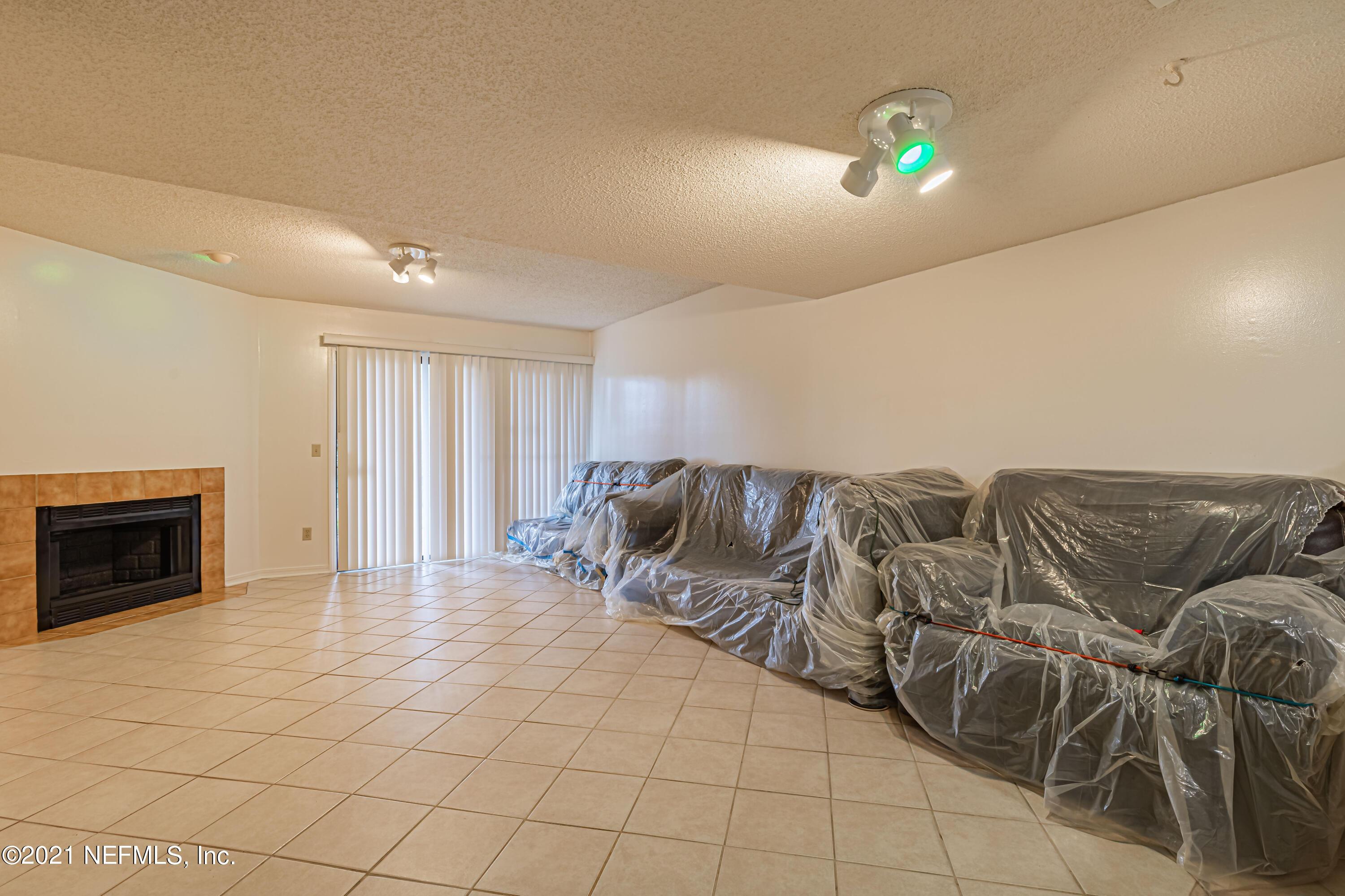 3517 Peeler Road, Unit 8 Jacksonville, FL 32277 - Photo 10 of 29 a living room with furniture and a fireplace