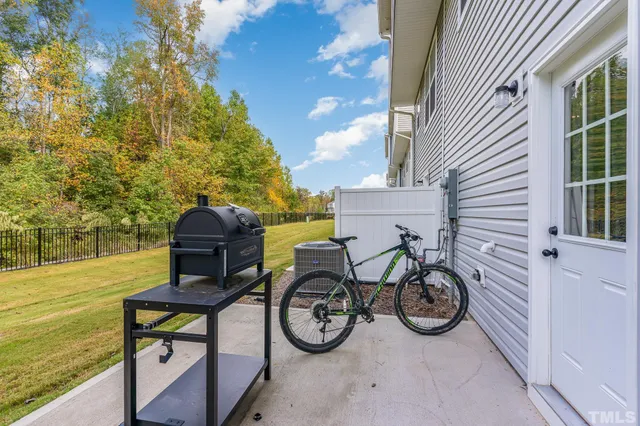 a big yard with trees in the background